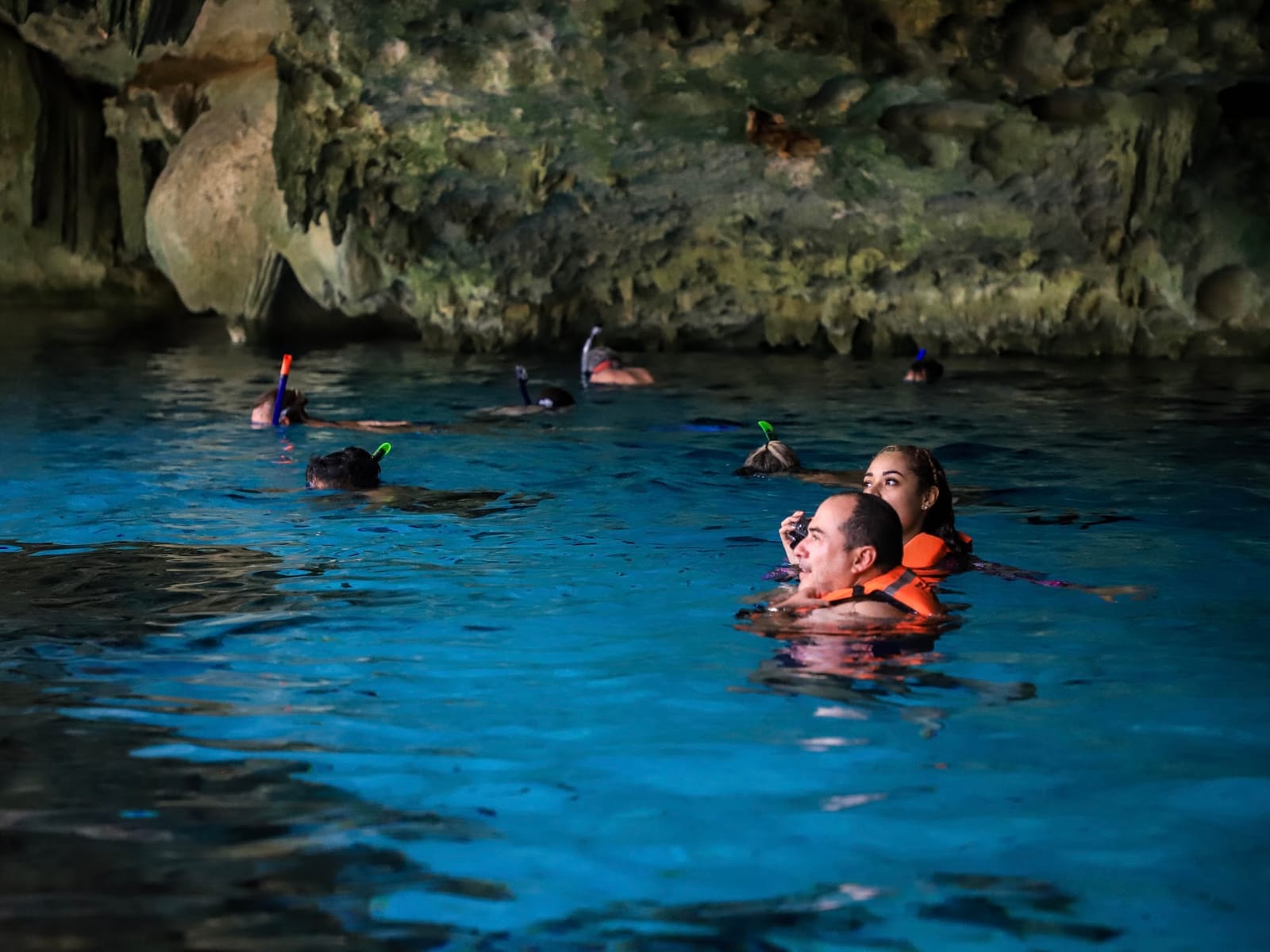 Guests in life jackets snorkelling in Cenote Dos Ojos