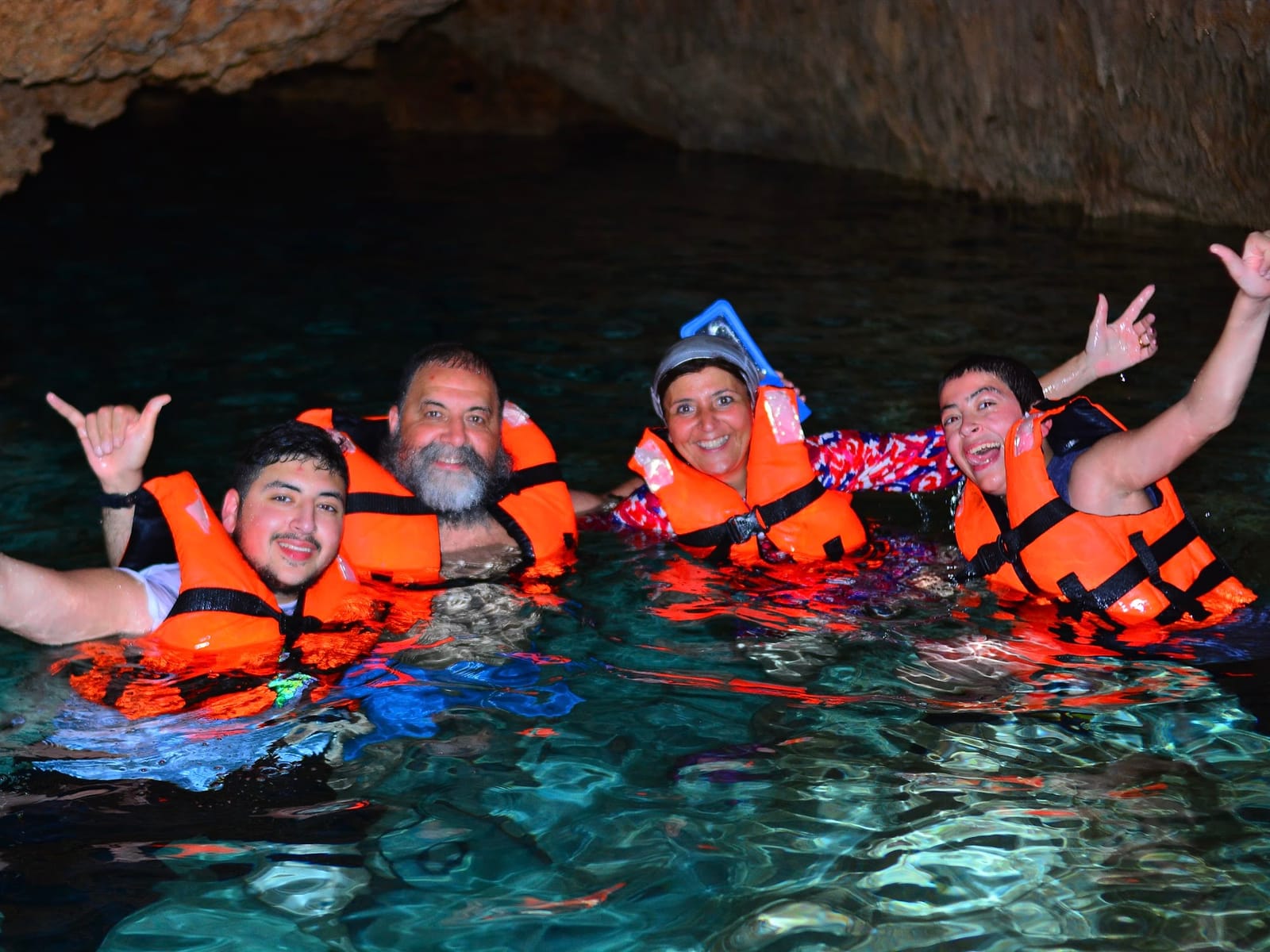 Group in life jackets swimming in Cenote Alux