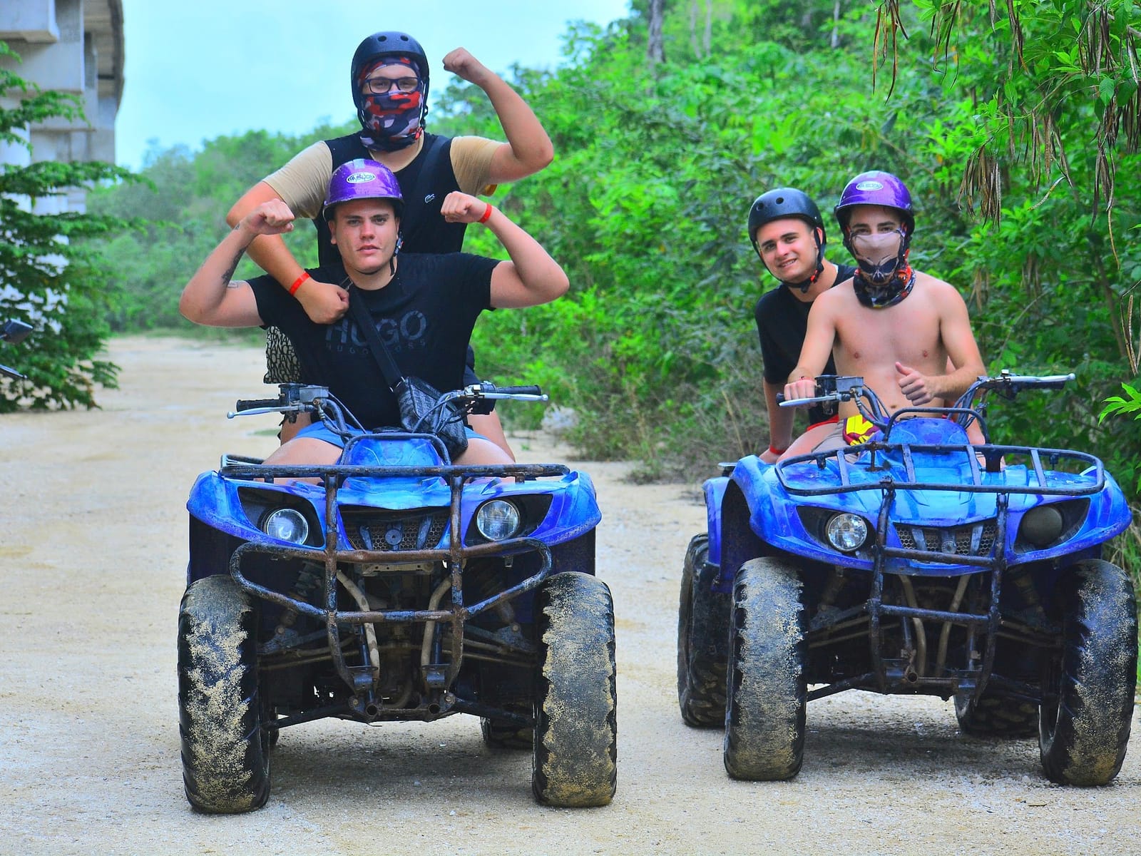 Small group posing by their ATVs after the jungle ride