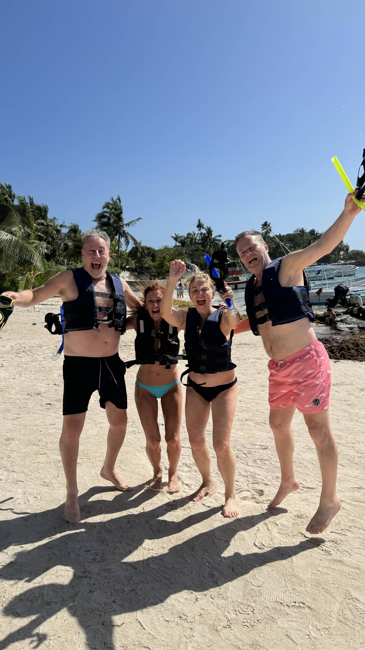 Group celebrating on Akumal beach after snorkel tour with sea turtles
