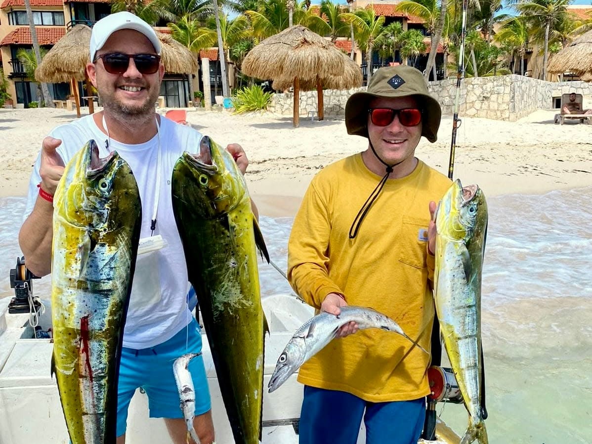 Back to the bay: guests on the beach with the day's mahi-mahi