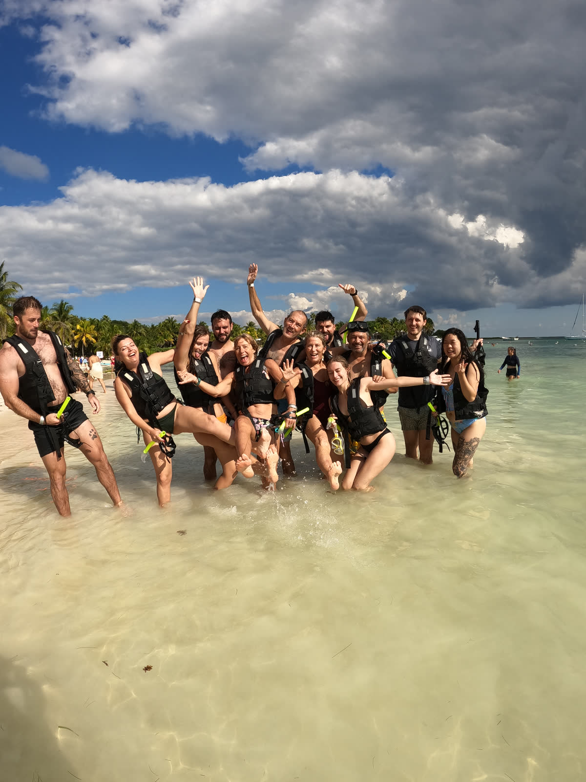 Happy snorkel group posing on Akumal beach after sea turtle swim