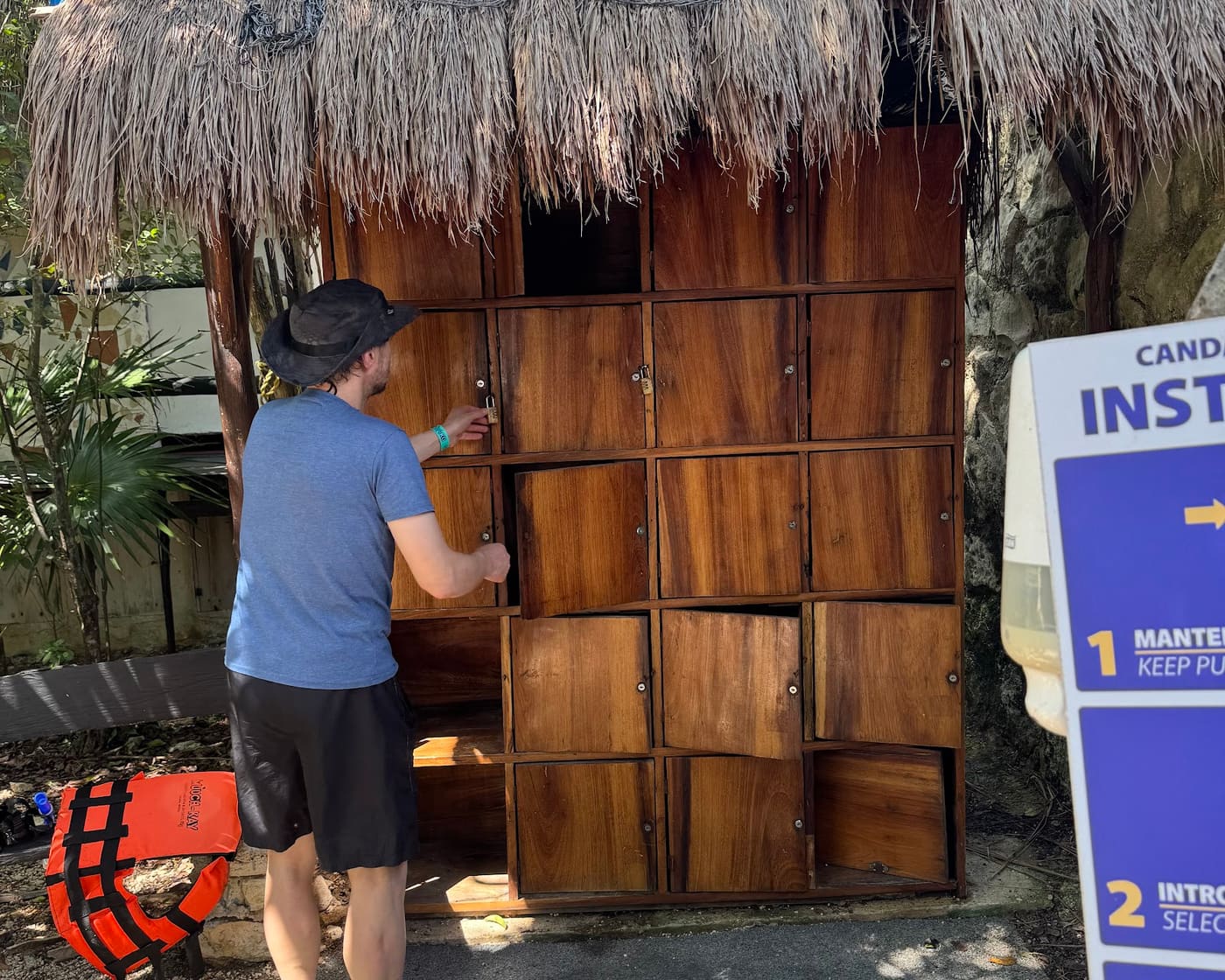Storing belongings in the included locker before snorkeling at Yal-Kú, life jacket ready