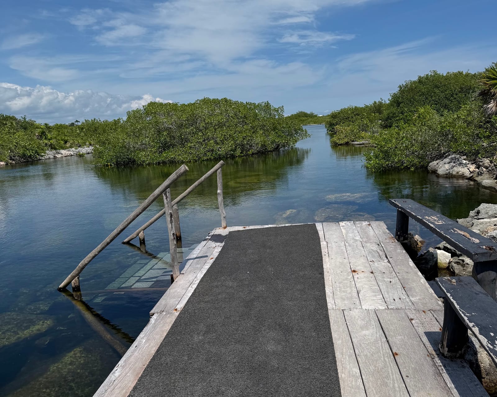 Wooden dock with steps leading into the water at Yal-Kú Lagoon